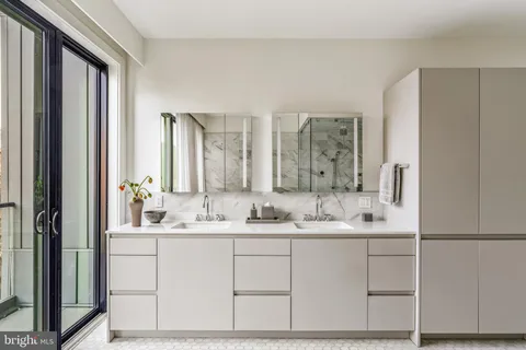 a bathroom with a double vanity sink mirror and