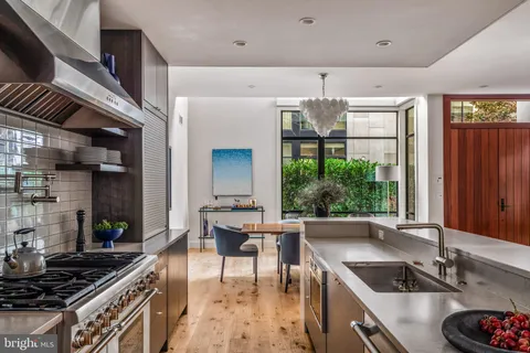 a kitchen with a sink and a stove top oven