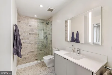 a bathroom with a sink mirror and a large window