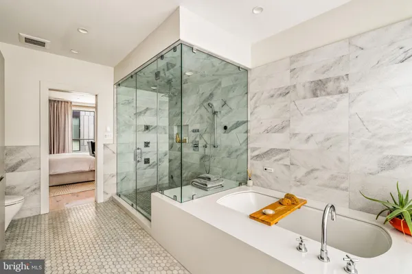 a bedroom with a bed and a view of bathroom