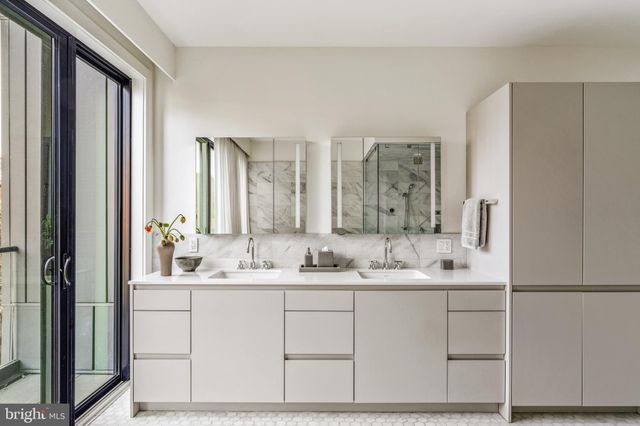 a view of a room with a large window and furniture