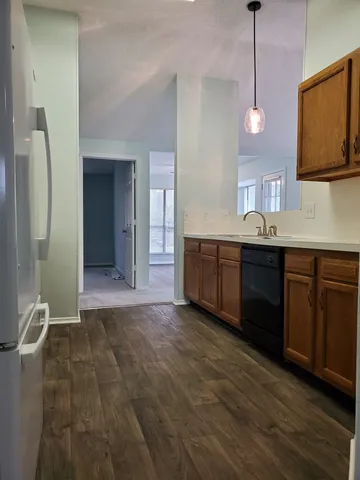 a view of a kitchen counter space and wooden floor