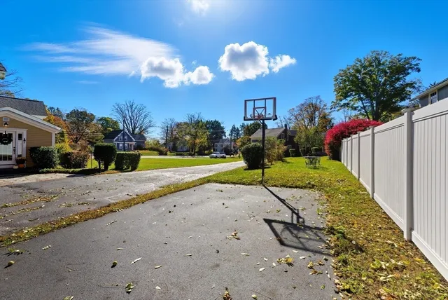 a view of a yard with a house in the background