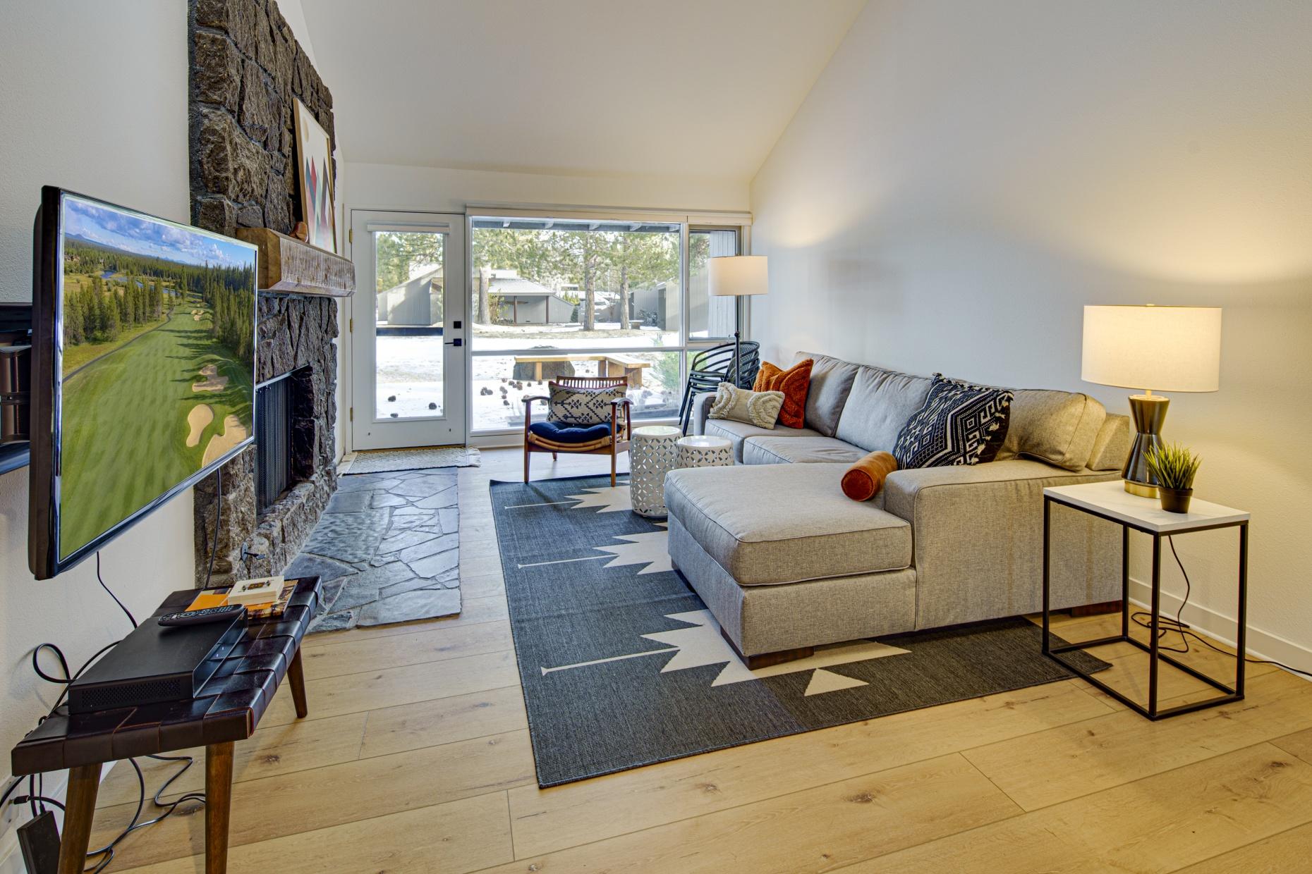 57257 Island Road Sunriver, OR 97707 - Photo 12 of 27 a living room with furniture and a flat screen tv