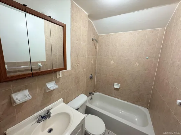 a bathroom with a toilet a sink and bathtub