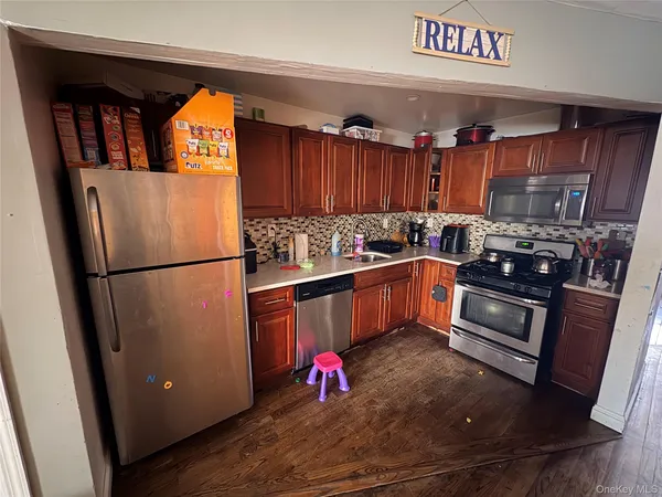 a kitchen with stainless steel appliances granite countertop a refrigerator sink and cabinets