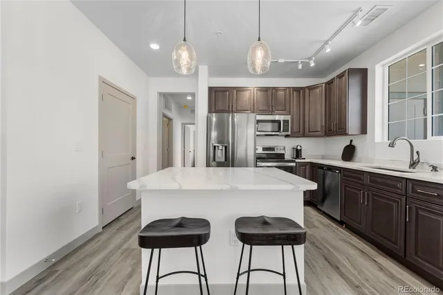 a kitchen with cabinets a sink and appliances