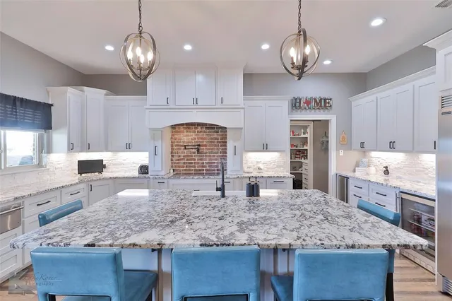 a kitchen with center island counter space cabinets and appliances