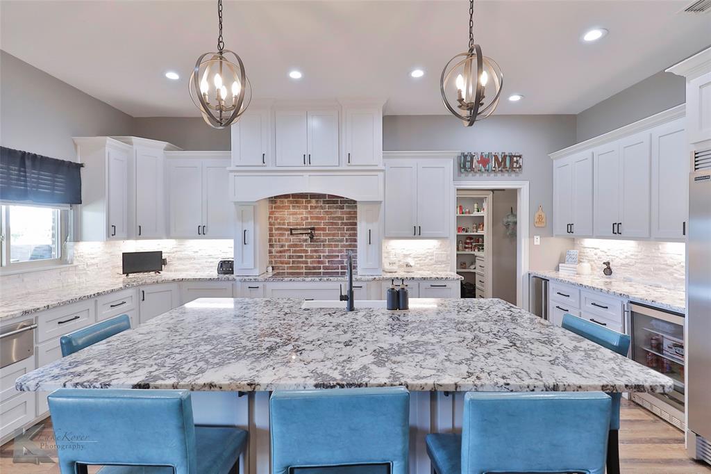 125 Wallace Court Tuscola, TX 79562 - Photo 12 of 40 a kitchen with center island counter space cabinets and appliances