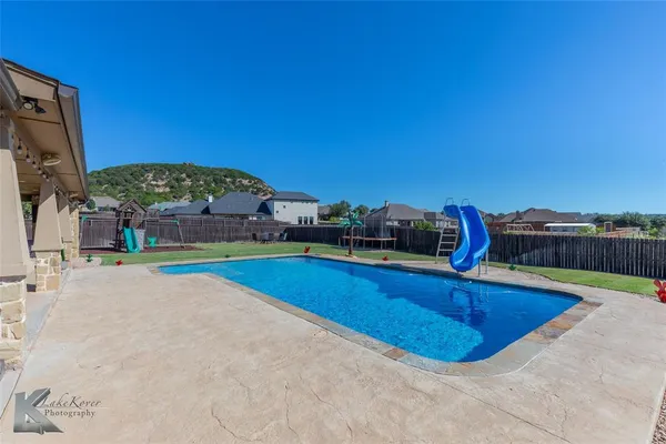a view of a swimming pool with a table and chairs
