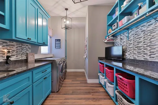 a kitchen with stainless steel appliances granite countertop a sink and cabinets
