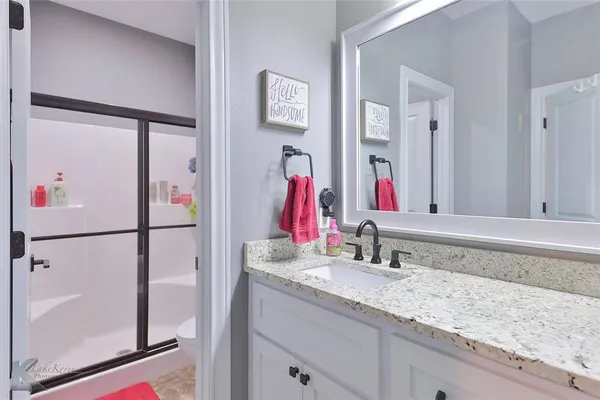 a bedroom with a bed and a desk