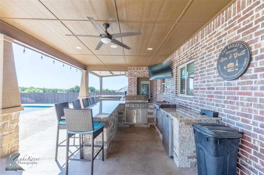 125 Wallace Court Tuscola, TX 79562 - Photo 35 of 40 a open kitchen with stainless steel appliances granite countertop a sink and cabinets