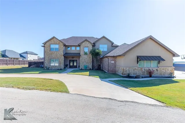 a front view of house with yard and outdoor seating