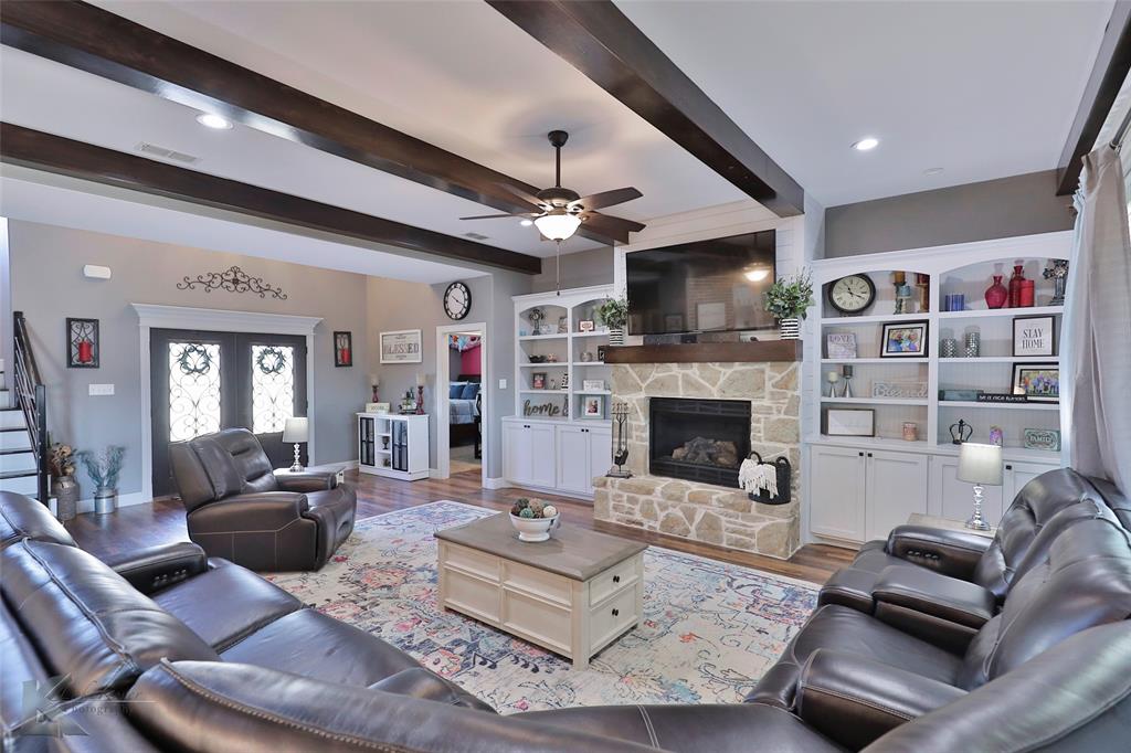 125 Wallace Court Tuscola, TX 79562 - Photo 6 of 40 a living room with furniture a flat screen tv and a fireplace