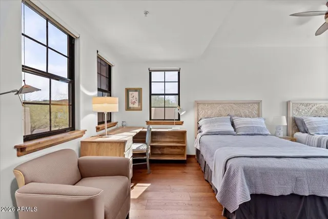 a bedroom with a bed and a large window