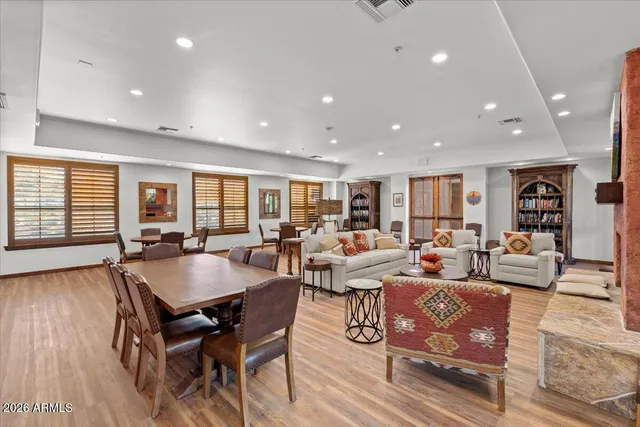 a living room with lots of furniture and wooden floor