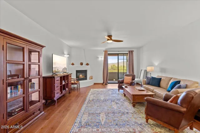 a living room with furniture a fireplace and a window