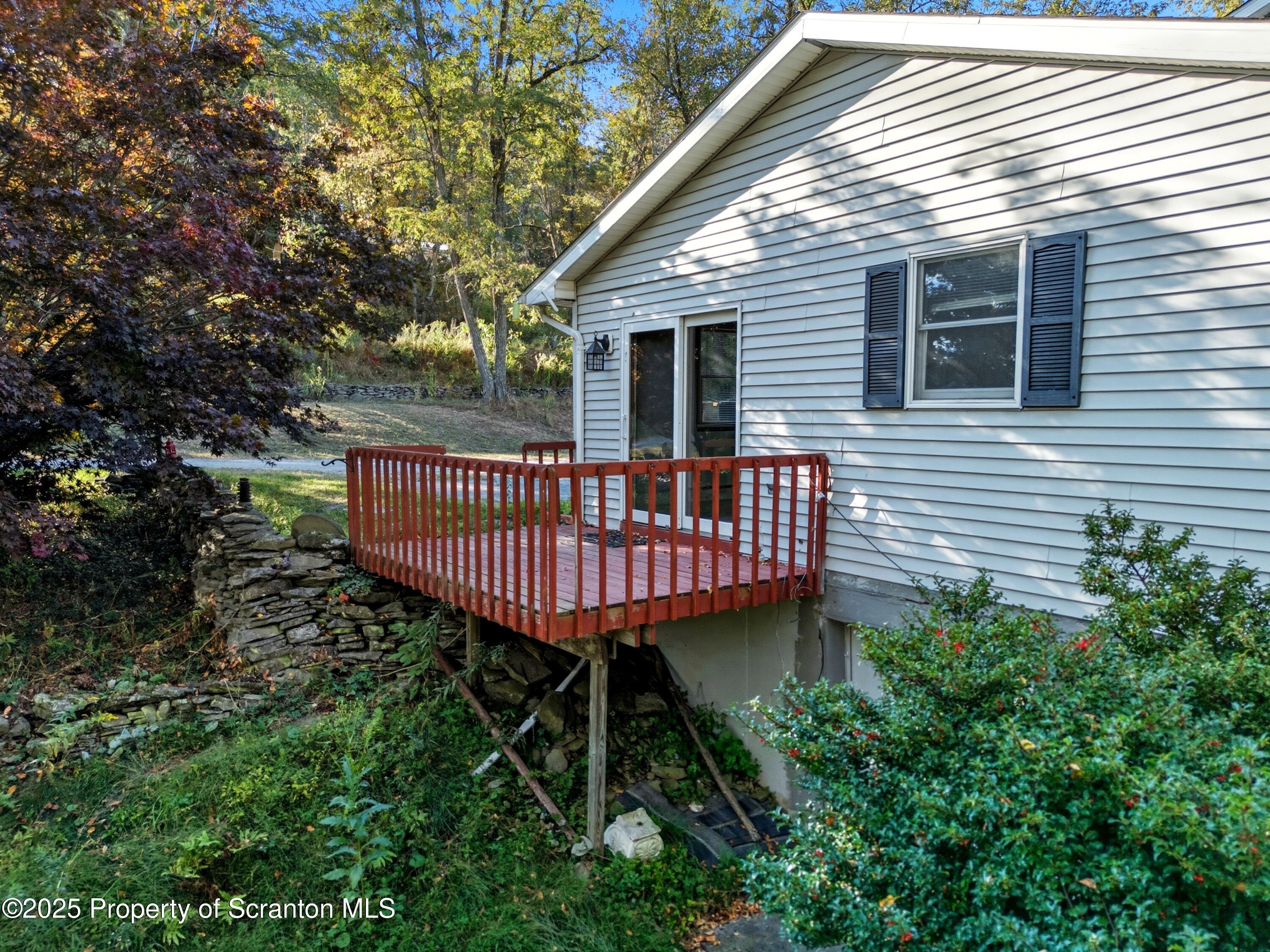398 Bennett Road Hop Bottom, PA 18824 - Photo 54 of 63 a view of a deck with a table and chair a barbeque with wooden fence