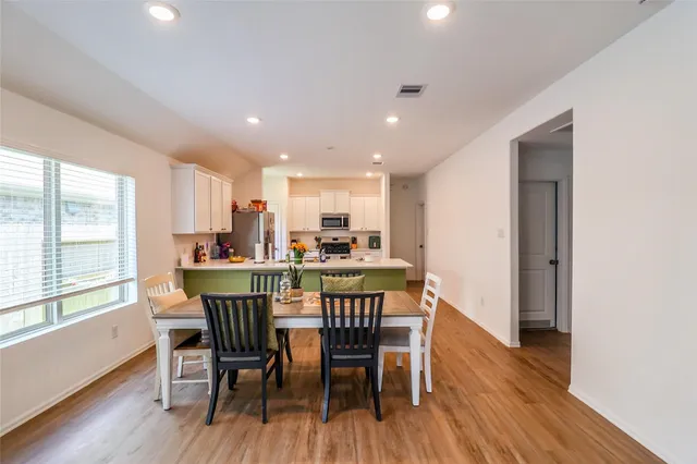 a view of a dining room with furniture window and wooden floor