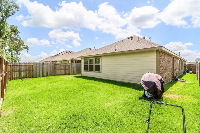 a backyard of a house with table and chairs