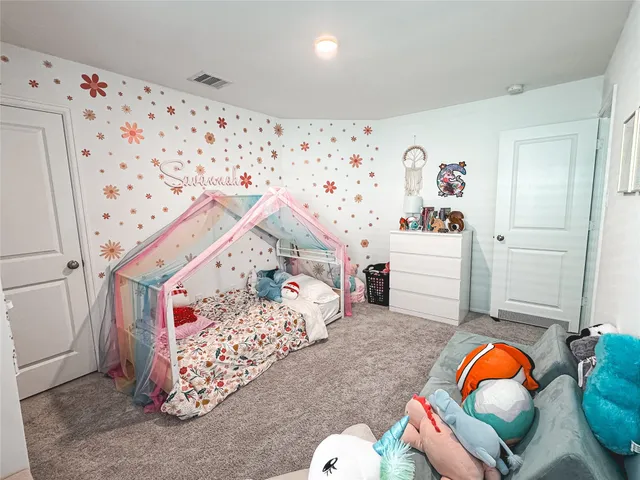 a bedroom with a bed and a couch