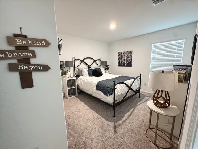 a bedroom with a bed and dresser