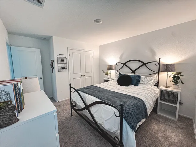 a bedroom with a bed and a dresser