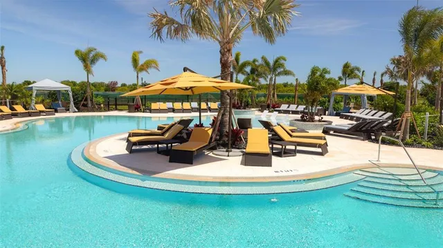 a view of a swimming pool with lounge chairs