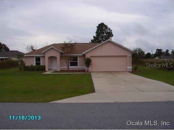 4709 Southwest 143rd Loop Ocala, FL 34473 - Photo 1 of 1 a front view of a house with a garden and yard