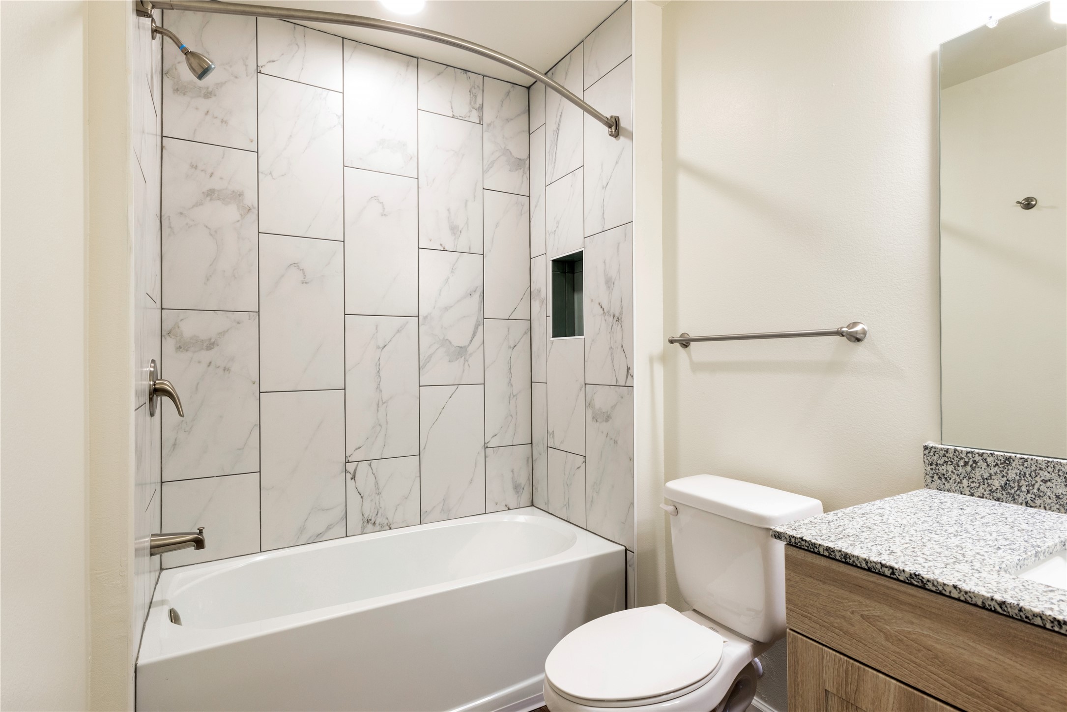1200 West Koenig Lane Austin, TX 78756 - Photo 15 of 22 a bathroom with a sink a toilet a mirror and a bathtub