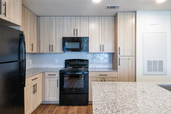 a kitchen with refrigerator and microwave