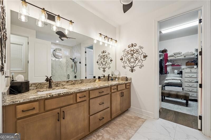 103 Rabun Court Hoschton, GA 30548 - Photo 12 of 22 a spacious bathroom with a granite countertop sink a mirror and shower