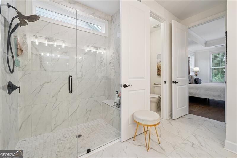 103 Rabun Court Hoschton, GA 30548 - Photo 13 of 22 a bathroom with a shower and a toilet