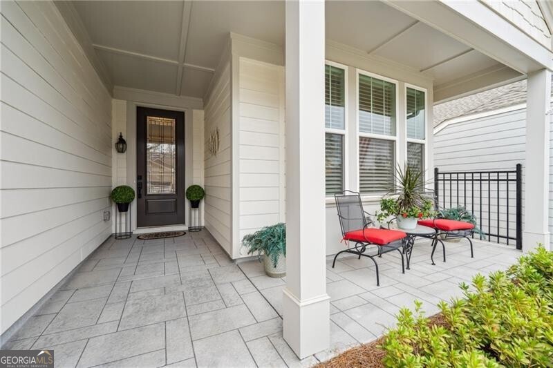 103 Rabun Court Hoschton, GA 30548 - Photo 2 of 22 a view of a porch with chairs
