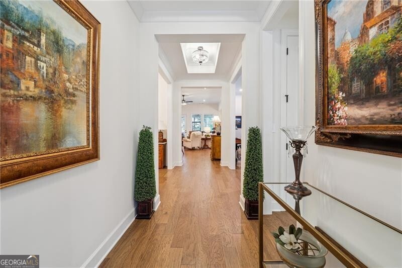 103 Rabun Court Hoschton, GA 30548 - Photo 3 of 22 a view of a hallway with wooden floor and a living room