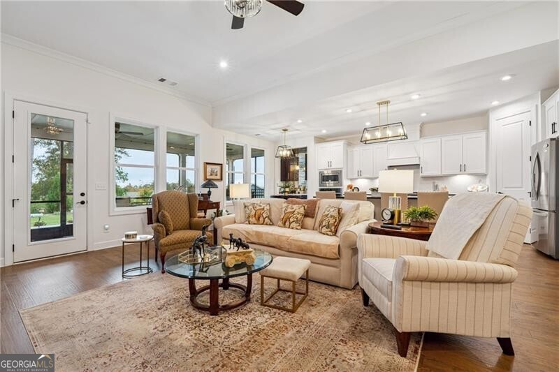 103 Rabun Court Hoschton, GA 30548 - Photo 5 of 22 a living room with furniture wooden floor and a large window