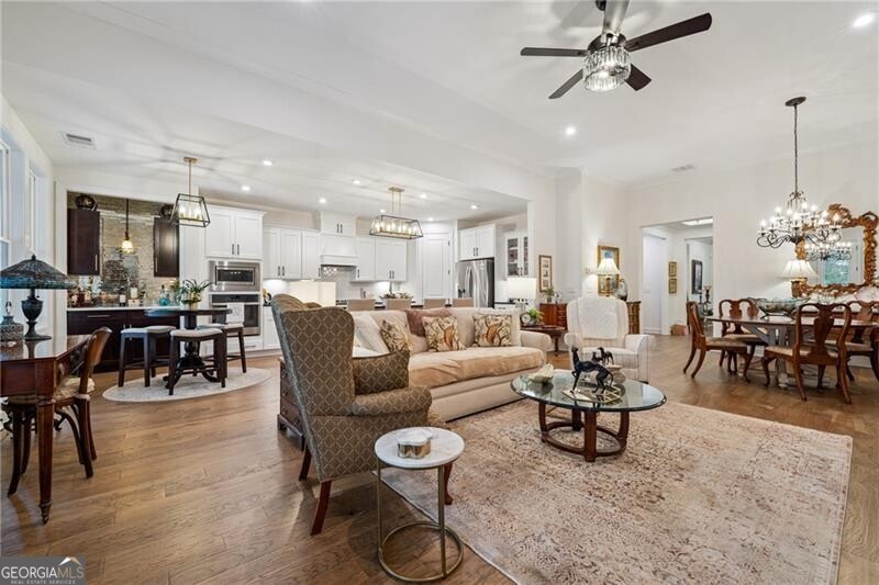 103 Rabun Court Hoschton, GA 30548 - Photo 6 of 22 a living room with lots of furniture and kitchen view