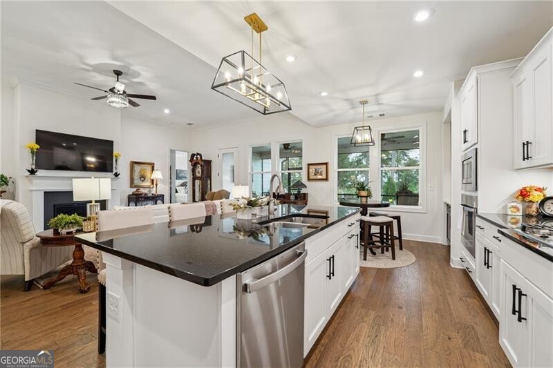 103 Rabun Court Hoschton, GA 30548 - Photo 21 of 22 a kitchen with a counter space a sink appliances and a counter top space