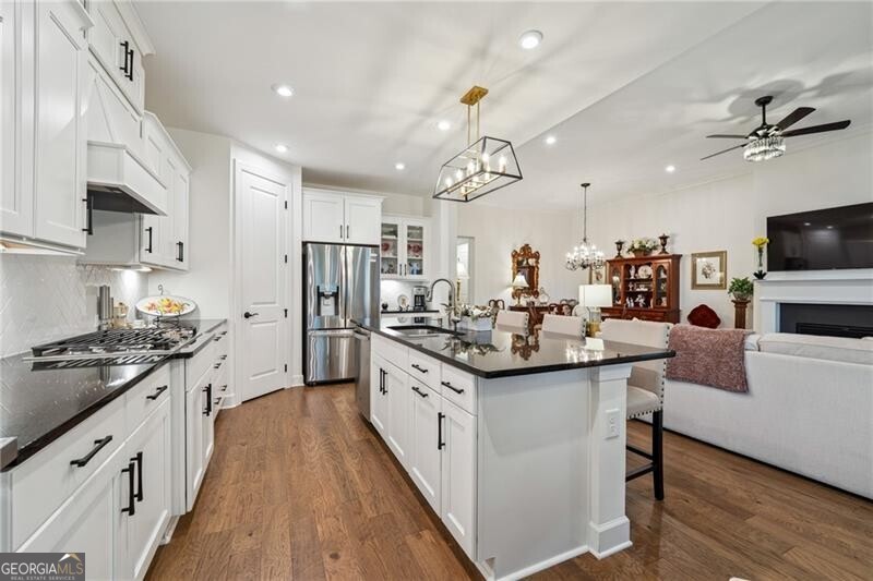103 Rabun Court Hoschton, GA 30548 - Photo 22 of 22 a kitchen with stainless steel appliances a sink stove and refrigerator