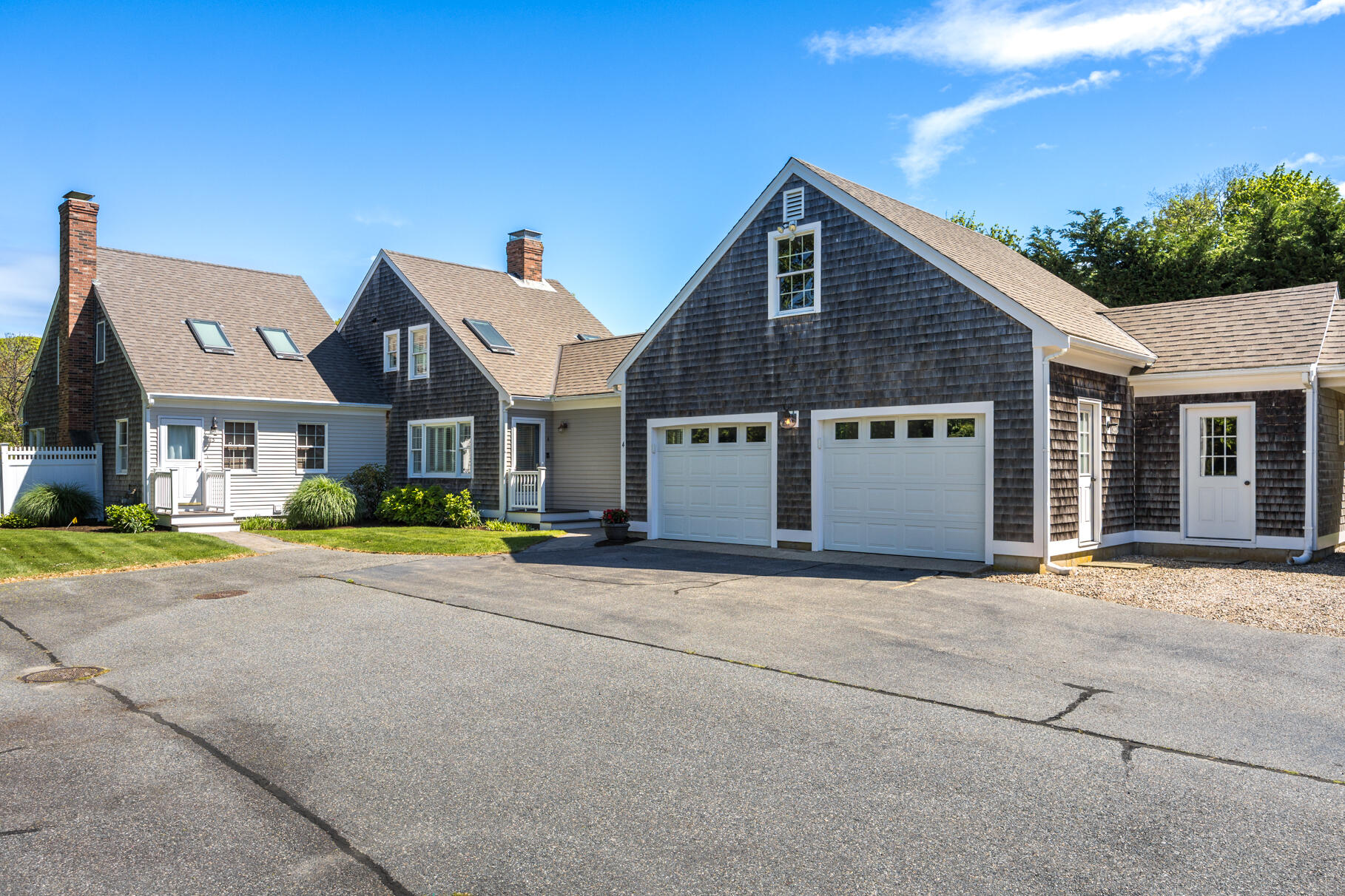 8 Beach Road, Unit 4 Orleans, MA 02653 - Photo 34 of 51 a front view of a house with a yard and garage