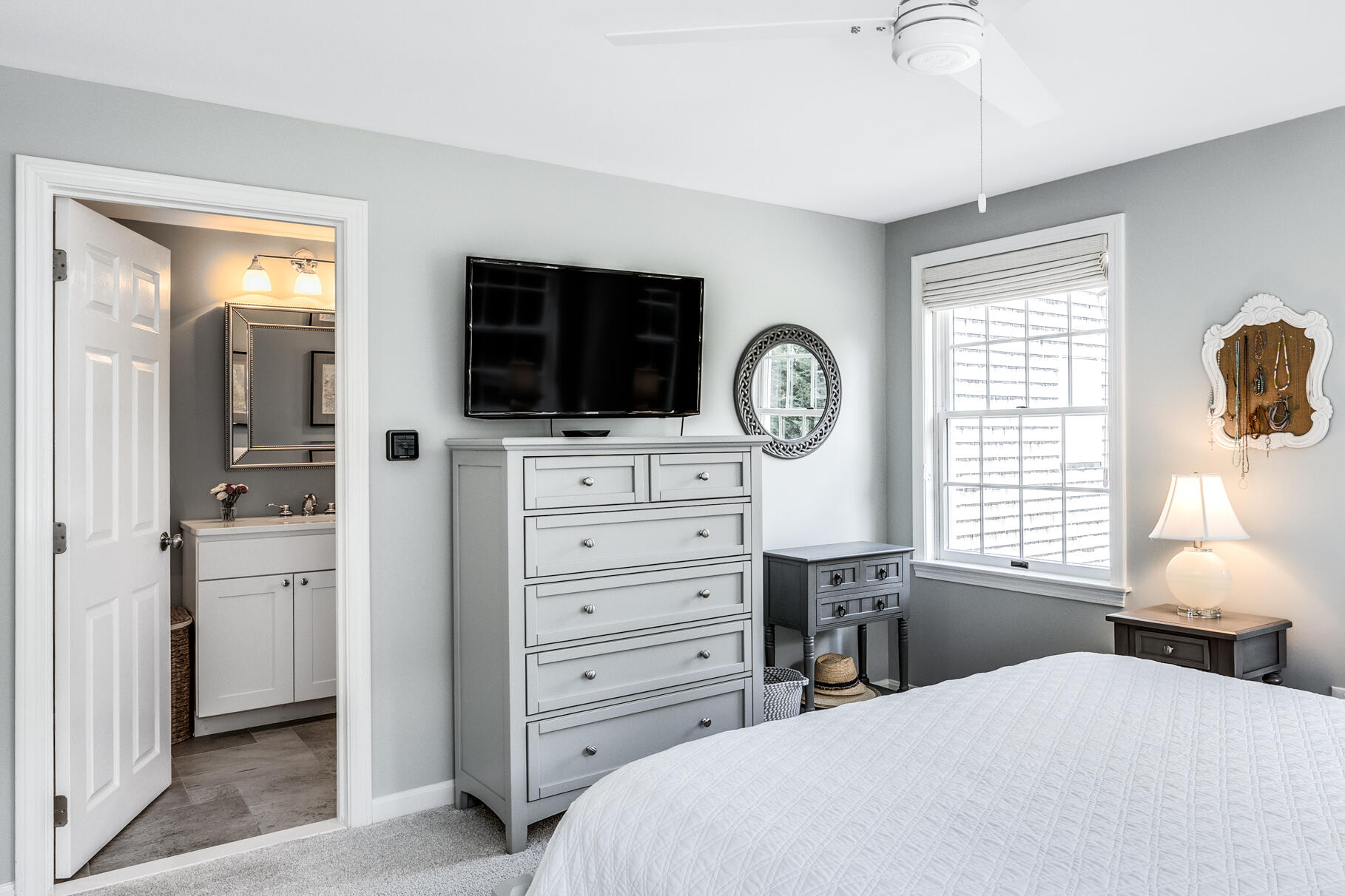 8 Beach Road, Unit 4 Orleans, MA 02653 - Photo 8 of 51 a bedroom with a bed a mirror and a flat tv screen on dresser