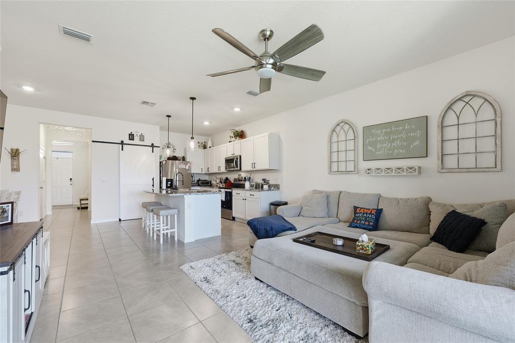 32992 Major Oak Drive Wesley Chapel, FL 33545 - Photo 11 of 56 a living room with furniture and kitchen view