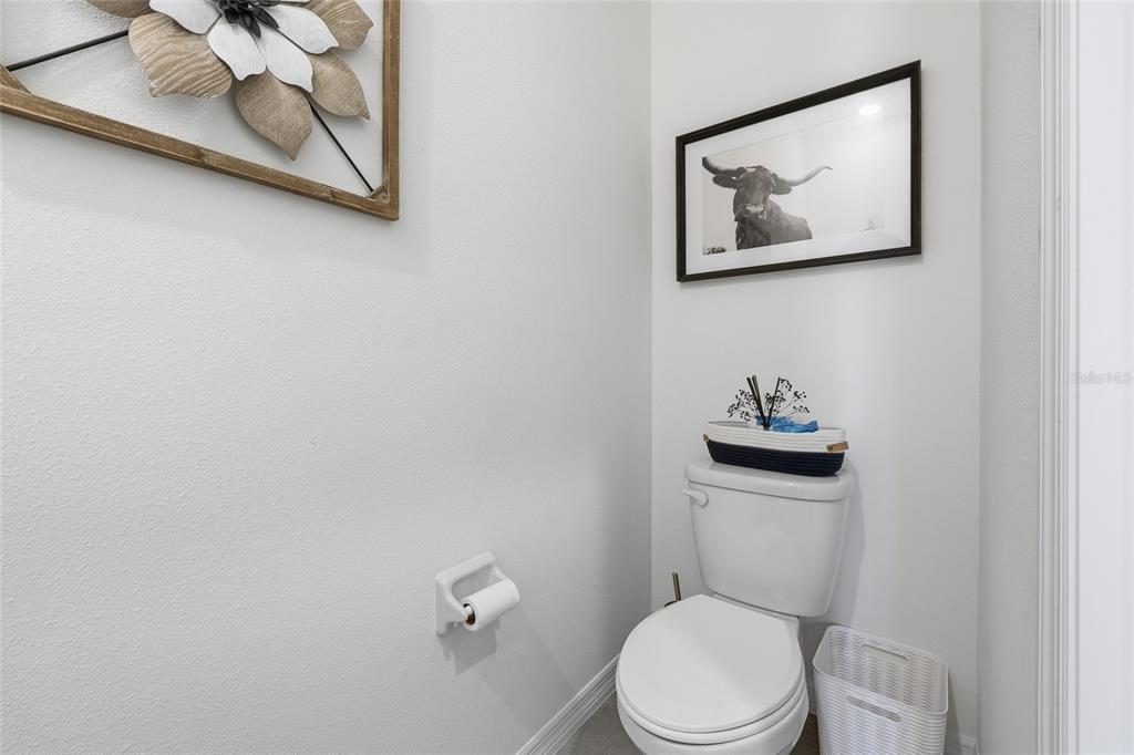 32992 Major Oak Drive Wesley Chapel, FL 33545 - Photo 13 of 56 a white toilet sitting next to a bathroom sink