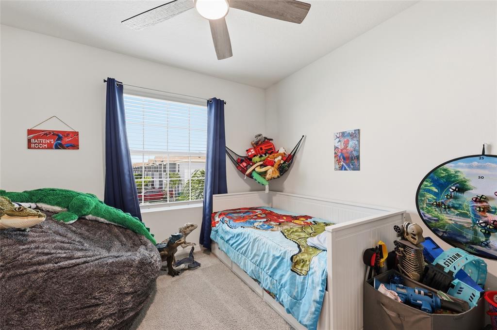 32992 Major Oak Drive Wesley Chapel, FL 33545 - Photo 23 of 56 a bedroom with bed and a large window