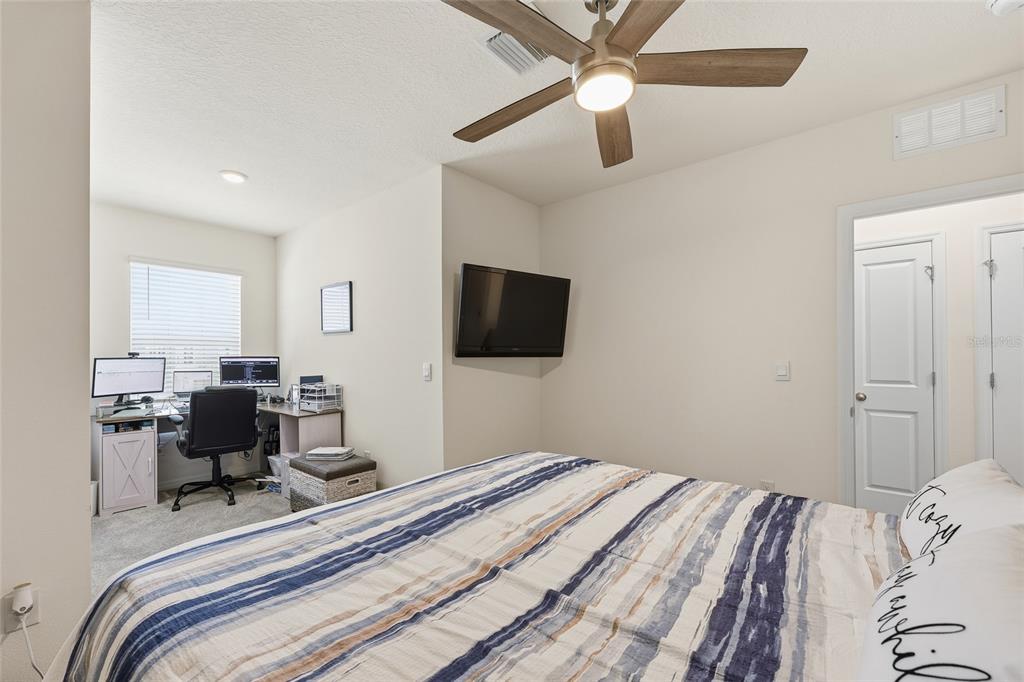 32992 Major Oak Drive Wesley Chapel, FL 33545 - Photo 26 of 56 a bedroom with a bed and a flat screen tv