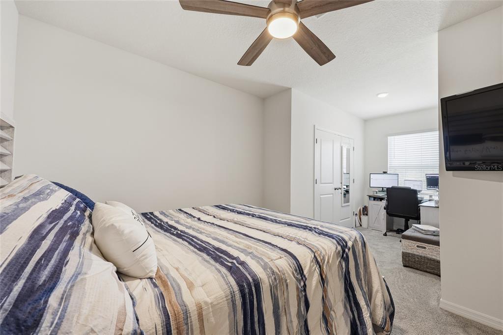 32992 Major Oak Drive Wesley Chapel, FL 33545 - Photo 28 of 56 a bedroom with a bed and a flat screen tv