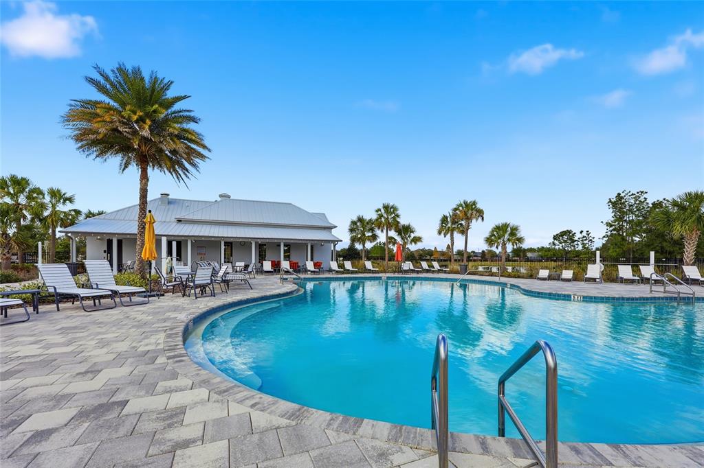 32992 Major Oak Drive Wesley Chapel, FL 33545 - Photo 39 of 56 a swimming pool with outdoor seating and yard