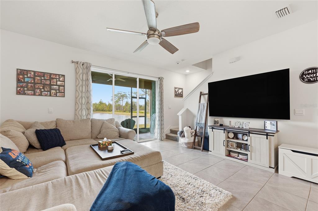 32992 Major Oak Drive Wesley Chapel, FL 33545 - Photo 10 of 56 a living room with furniture and a flat screen tv