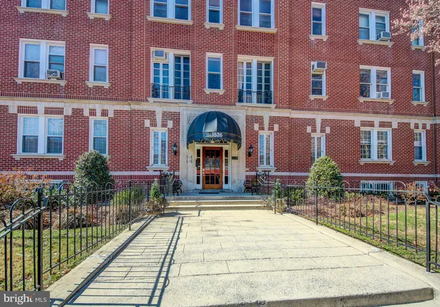 a front view of a building with a garden